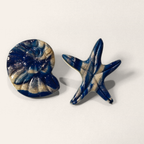 Navy Shell & Starfish Mismatched Stud Earrings, angled view showing the pattern