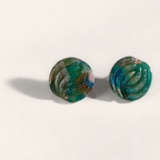 Green marbled round polymer clay studs with parallel curved ridges, angled view