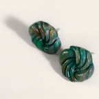 Green marbled round polymer clay studs with spiral ridges, angled view