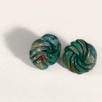 Green marbled round polymer clay studs with spiral ridges, angled view