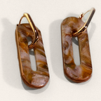 Brown Marble Cut-Out Oblong Hoop Earrings, angled view showing the pattern