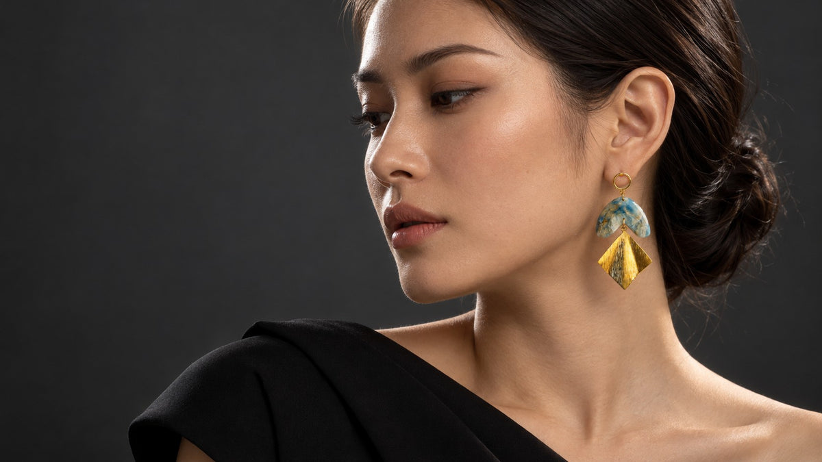Model wearing ToBe handmade blue marble polymer clay earrings with gold drop